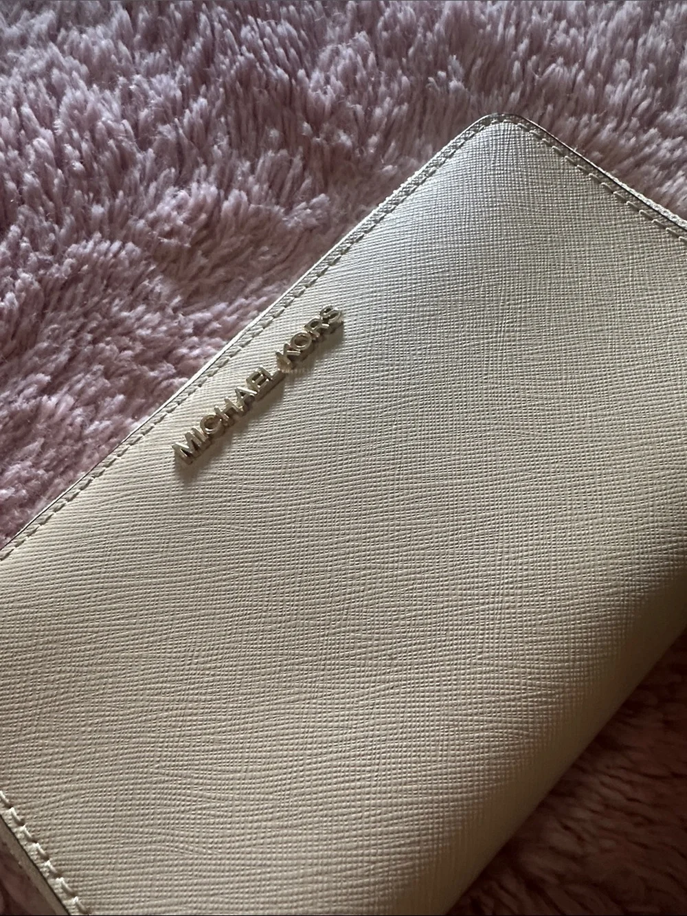 MK wristlet in light tan/ Beige